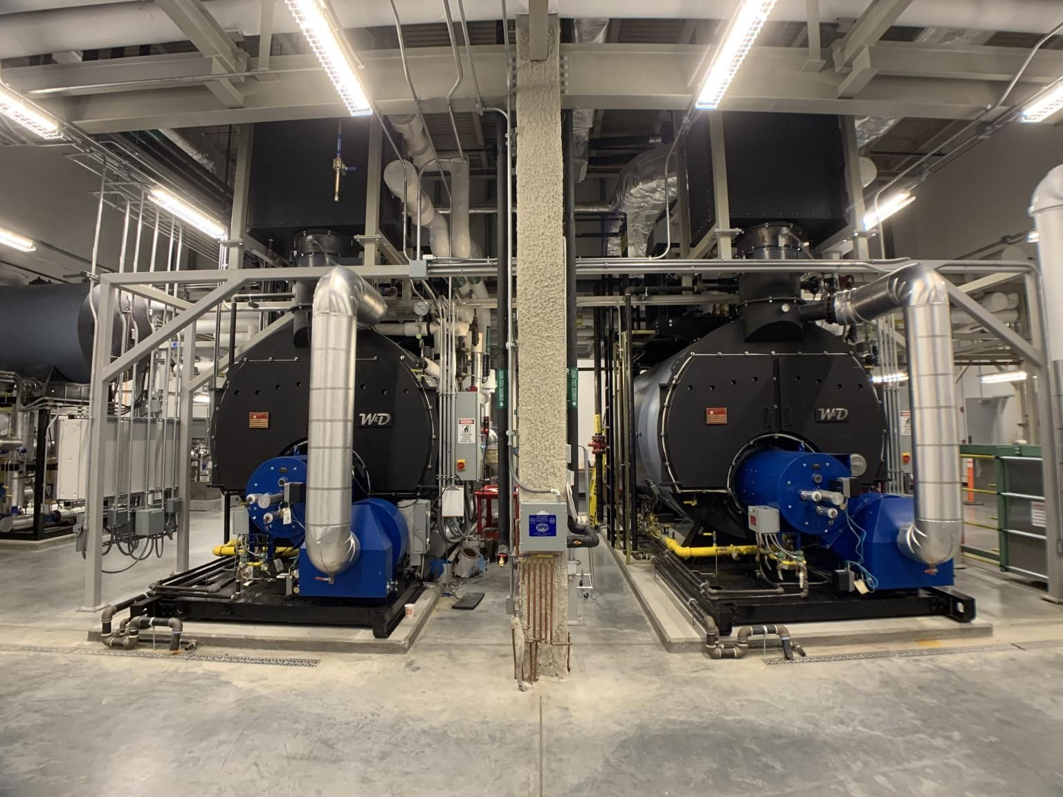 HeatSponge economizers mounted above industrial steam boilers