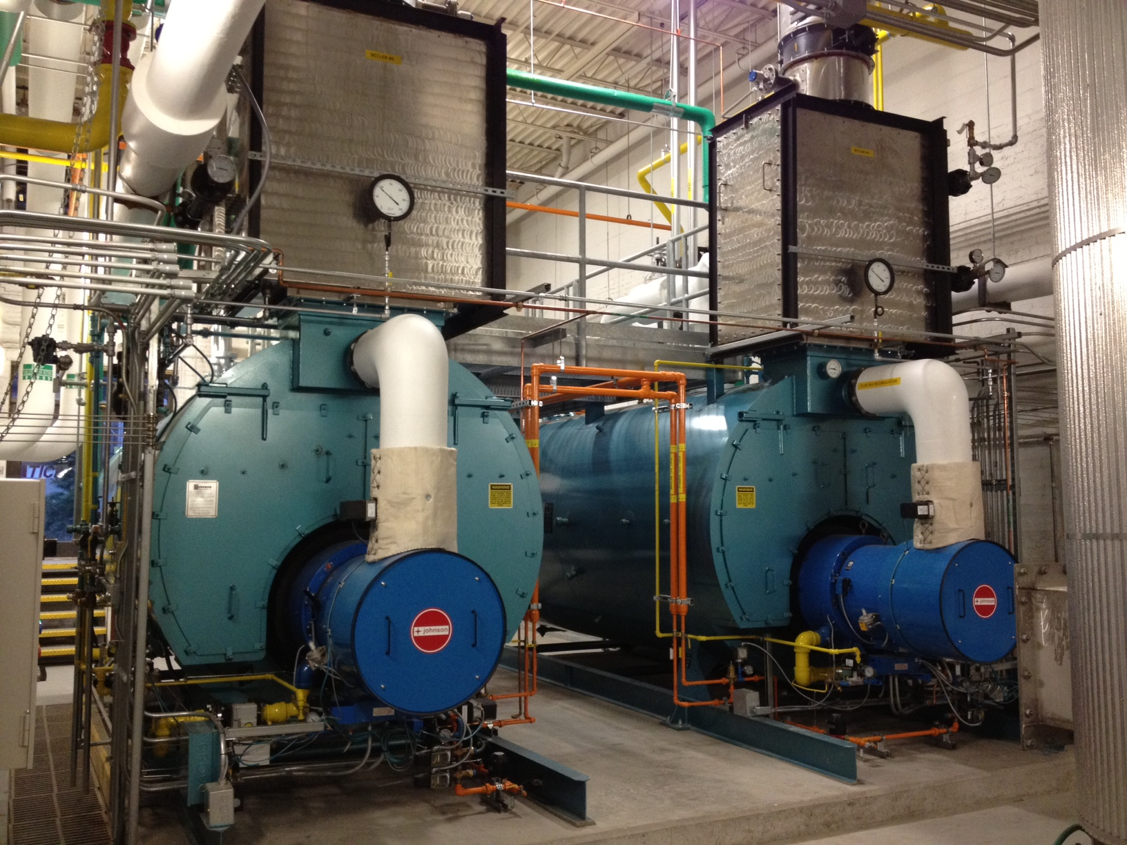 Two HeatSponge economizers installed above industrial steam boilers